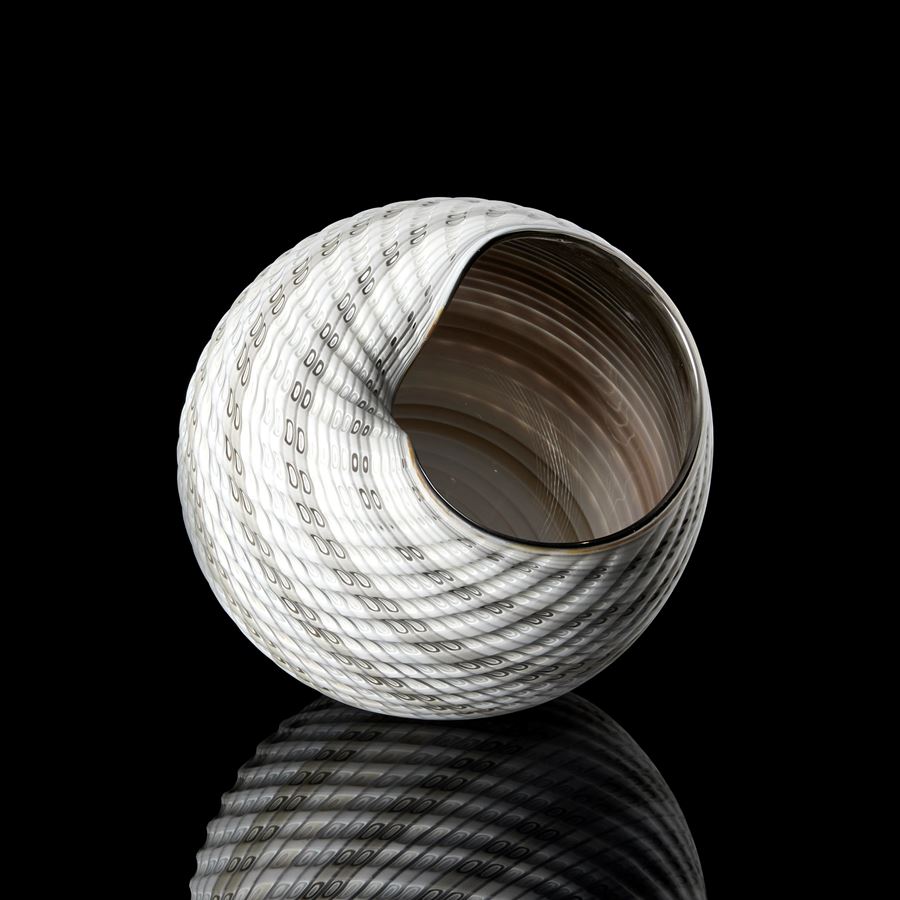 shell like round off white with soft grey coloured banded vessel with incised cut and patterned surface and shiny interior handmade from glass